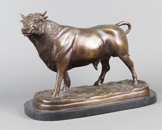 A bronze figure of a standing bull, raised on oval marble base 24cm x 37cm x 15cm 