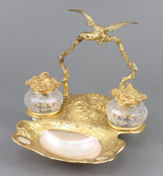 A 19th Century gilt metal twin bottle inkwell with polished shell bowl to the centre surmounted by a figure of an eagle 17cm h x 20cm w x 20cm d (1 glass inkwell a/f) 