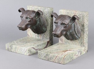 A pair of 20th Century polished granite and bronze book ends decorated dogs masks 21cm x 22cm x 15cm 