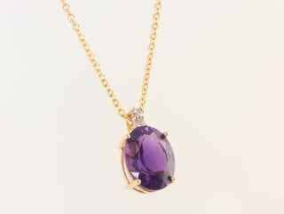 An 18ct yellow gold oval amethyst and diamond pendant, the amethyst 1.5ct, the diamond 0.01ct, hung on an 18ct chain 40cm, 2.3 grams 