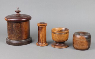 A Victorian cylindrical lignum vitae string box 17cm x 16cm, a ditto stable block 8cm x 9cm, a turned lignum vitae pedestal bowl 10cm and a ditto caster 12cm x 7cm 