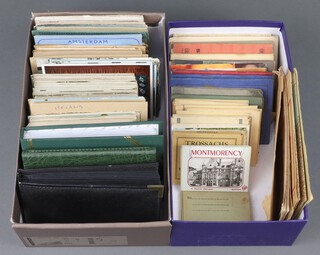 A collection of black and white and coloured postcards contained in 2 shallow boxes