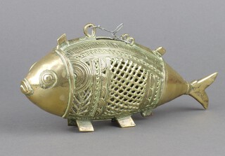 A Benin style pierced polished gilt metal model of a fish 11cm x 43cm 