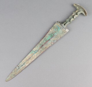 An ancient bronze Luristan dagger with 24cm blade, recessed handle and crescent shaped pommel 