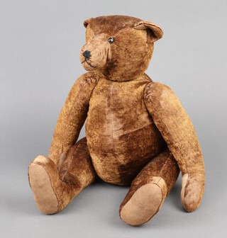 An early 20th Century Steiff style brown mohair wood wool bear with boot button eyes and stitched long snout,  elongated arms and legs and humped back, 50cm 