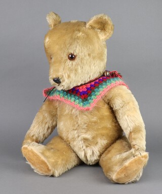 A mid-20th Century mohair bear with glass eyes, stitched snout and plastic nose 69cm 