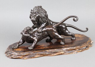 A Meiji period bronze group of a lion fighting a tiger, seal mark to base, 45cm, raised on a wooden stand 