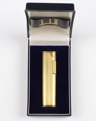 A Dunhill gold plated engine turned cigarette lighter, boxed