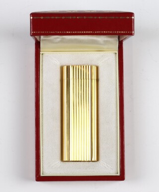 A Cartier gilt cigarette lighter boxed 