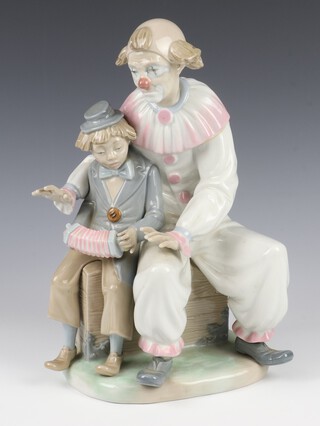 A Nao group of a clown and boy playing a concertina 30cm 