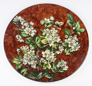 A Doulton faience charger decorated with a butterfly amongst flowers 38cm 