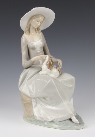 A Lladro figure of a seated lady with a puppy on her lap 30cm 