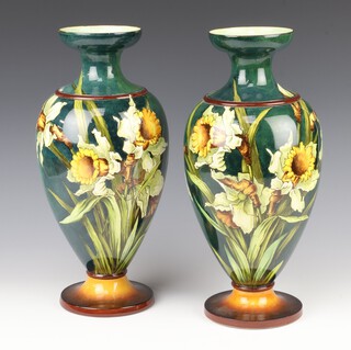 A pair of Doulton faience oviform vases decorated with daffodils no.2083, 36cm 