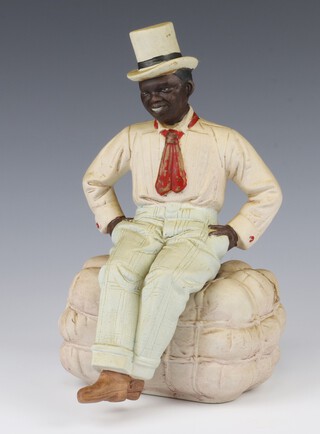 A bisque porcelain figure of a gentleman wearing a top hat sitting on a bale of cotton no.149 27cm 