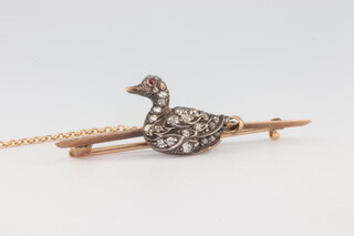 An Edwardian yellow gold testing as 9ct  bar brooch in the form of a swan with diamond body and ruby eye, 3.4 grams, 40mm 