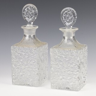 A near pair of Whitefriars clear glass "Glacier" decanters with flattened stoppers 27cm 