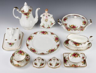 An extensive Royal Albert Old Country Roses tea and dinner service comprising 6 dinner plates, 4 medium plates (2 seconds), 6 side plates (5 seconds), 4 dessert bowls (all seconds),  6 twin handled soup bowls (1 second) and 6 saucers, 7 tea cups, 4 coffee cups (3 seconds) and 9 saucers, vase, cheese dish and cover, coffee pot, small teapot (second), a milk jug (second), sugar bowl, sugar bowl with lid (second), 2 tureens and covers, pair of candlesticks, 2 circular serving platters, 2 twin handled dishes (1 second), a rectangular dish, an octagonal dish, a sauce boat (second) and stand, an oval dish and a small circular dish (second), a figure, 2 knives (1 cased) and a spoon (cased)