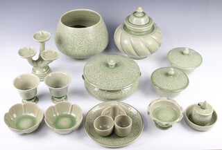 An extensive 20th Century "Thai Celadon" green crackled glazed dinner service comprising 12 lidded bowls, tureen and cover, deep bowl, vase and cover, 16 small bowls, 12 small lobed bowls, 14 pedestal cups, 28 small plates, 14 medium plates, 16 dinner plates, sauce boat and stand, a condiment, 2 pedestal bowls, 4 serving plates, 2 condiments and 2 three light candle holders 