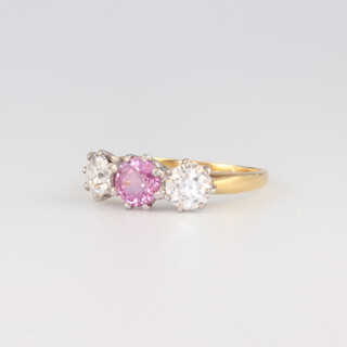 A yellow gold testing as 9ct pink sapphire and diamond ring, the pink sapphire approx. 0.5ct, the 2 outer diamonds each approx. 0.5ct, 2.9 grams, size M 1/2