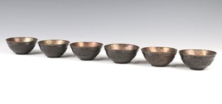 Six Chinese carved coconut bowls with metal lining, decorated with scrolling flowers beneath  Greek Key pattern decoration 9cm 