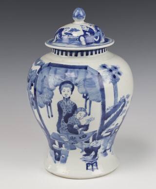 A 19th Century Chinese blue and white baluster vase and cover, decorated with figures in a pavilion garden beneath trees with 4 character Kangxi marks to base 32cm 