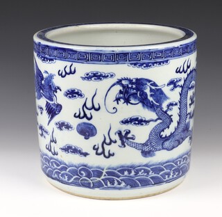 A Chinese Antique style blue and white circular jardiniere decorated with dragons 32cm 