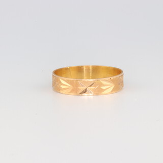 A yellow gold testing as 18ct wedding band 1.1 grams, size K 1/2