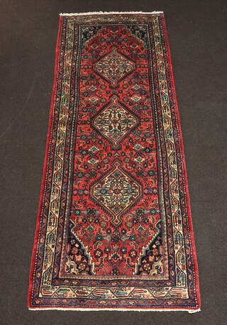 A red and blue ground Afghan runner with 3 diamonds to the centre 303cm x 105cm 