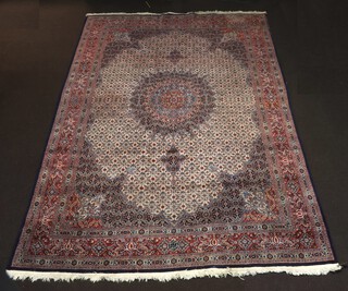 A red, white and blue North Persian floral patterned carpet with central medallion within a multi row border 365cm x 254cm 