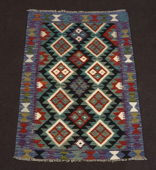 A black, blue and brown ground Chobi Kilim rug with all over diamond design 124cm x 177cm 