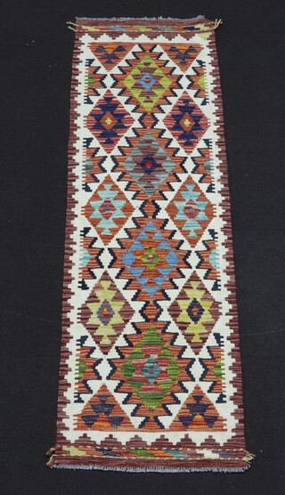 A white, tan and turquoise ground Chobi Kilim runner with 4 diamond medallions to the centre 195cm x 60cm 