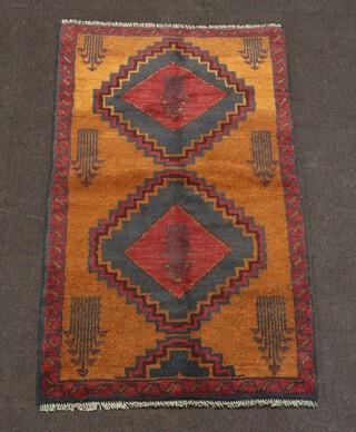 A black and brown ground Belouche rug with 2 stylised diamond medallions to the centre 139cm x 83cm 