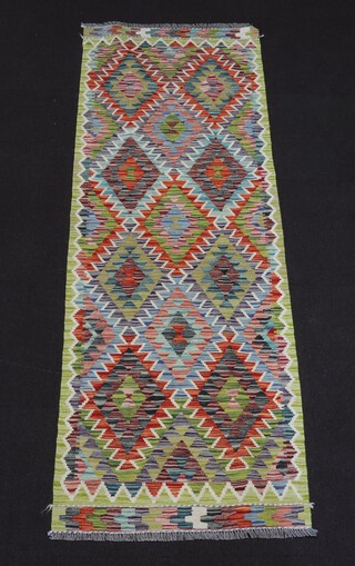 A turquoise, green and orange ground Chobi Kilim runner 240cm x 82cm 