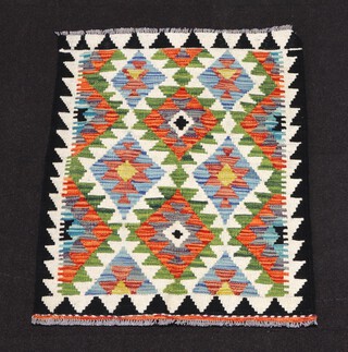 A white, black and green ground Chobi Kilim rug with overall geometric design 87cm x 67cm 