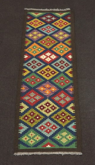 A brown, black and green ground Maimana Kilim runner with all over geometric design 200cm x 67cm 