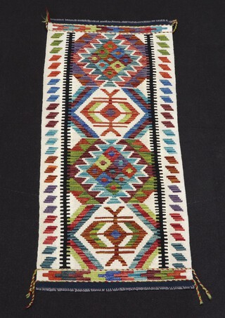 A white, green and turquoise ground Chobi Kilim runner with 4 diamond shaped medallions to the centre 147cm x 65cm 