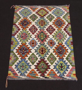 A white and green ground Chobi Kilim rug with all over geometric designs 152cm x 106cm 