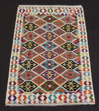 A white, black, brown and tan ground Chobi Kilim rug with all over geometric design 196cm x 125cm 