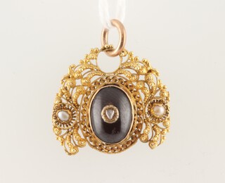 A yellow gold testing as 14ct pendant set with a cabochon cut garnet, diamond and pearls (a/f), 3.6 grams 