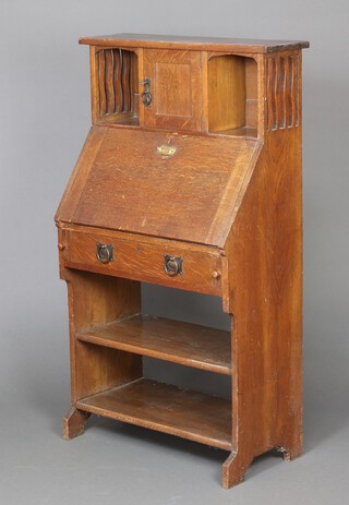 A Liberty style oak Art Nouveau student's bureau, the upper section fitted a cupboard flanked by recesses above a fall front, recess and shelf 132cm h x 71cm w x 39cm d 