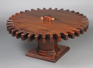 Ethan Allen, a 1970's American pine Gear Cog Wheel revolving table, raised on an octagonal column with stepped square base, from The Old Tavern Collection,  45cm x 96cm diam. 