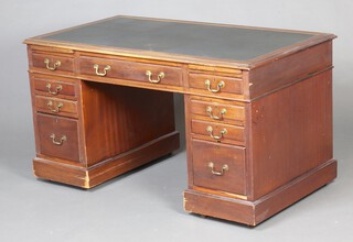 A mahogany kneehole desk with green inset writing surface, fitted brushing slides, 1 long and 8 short drawers 73cm h x 137cm w x 76cm d 