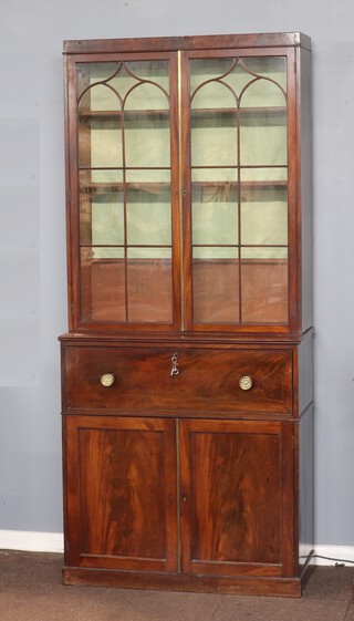 A Georgian secretaire bookcase, the upper section fitted adjustable shelves enclosed by astragal glazed panelled doors, the base fitted a secretaire drawer above double cupboard enclosed by panelled doors 226cm h x 101cm w x 44cm d 