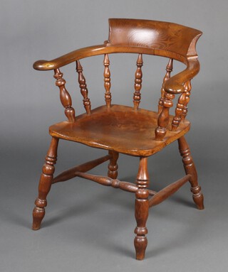 A 19th Century elm smokers bow armchair with spindle back and solid seat, raised on turned supports with H framed stretcher 78cm h x 68cm w x 41cm d (seat 30cm x 28cm) 