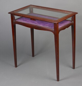 An Edwardian rectangular mahogany bijouterie table with bevelled glass panel to the top, raised on square tapered supports 70cm h x 69cm w x 69cm d 