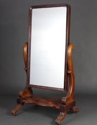 A Victorian arched plate cheval mirror contained in a mahogany swing frame, the base of serpentine outline raised on scrolled s supports 165cm h x 84cm w 