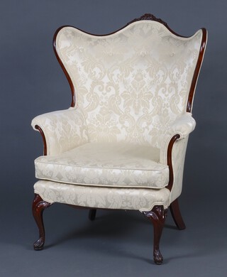 A Victorian carved mahogany show frame armchair upholstered in cream material raised on cabriole supports 111cm h x 68cm w x 56cm d (seat 41cm x 43cm) 