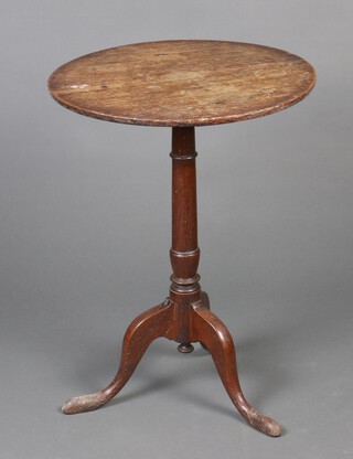 An 18/19th Century oak wine table, raised on a pillar and tripod base 67cm h x 51cm diam. 