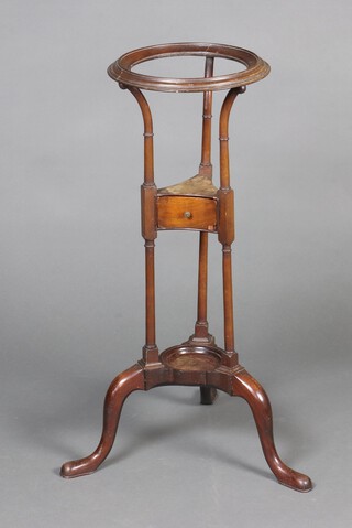 A Georgian mahogany circular wash stand, the base fitted a drawer, raised on outswept supports 81cm h x 30cm diam. 