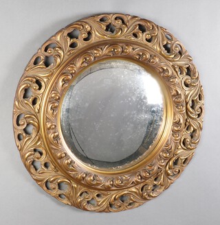 A circular convex wall mirror contained in a pierced gilt hardwood frame 61cm diam. 